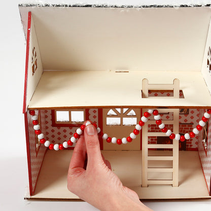 The Elf Decorating Santa's House